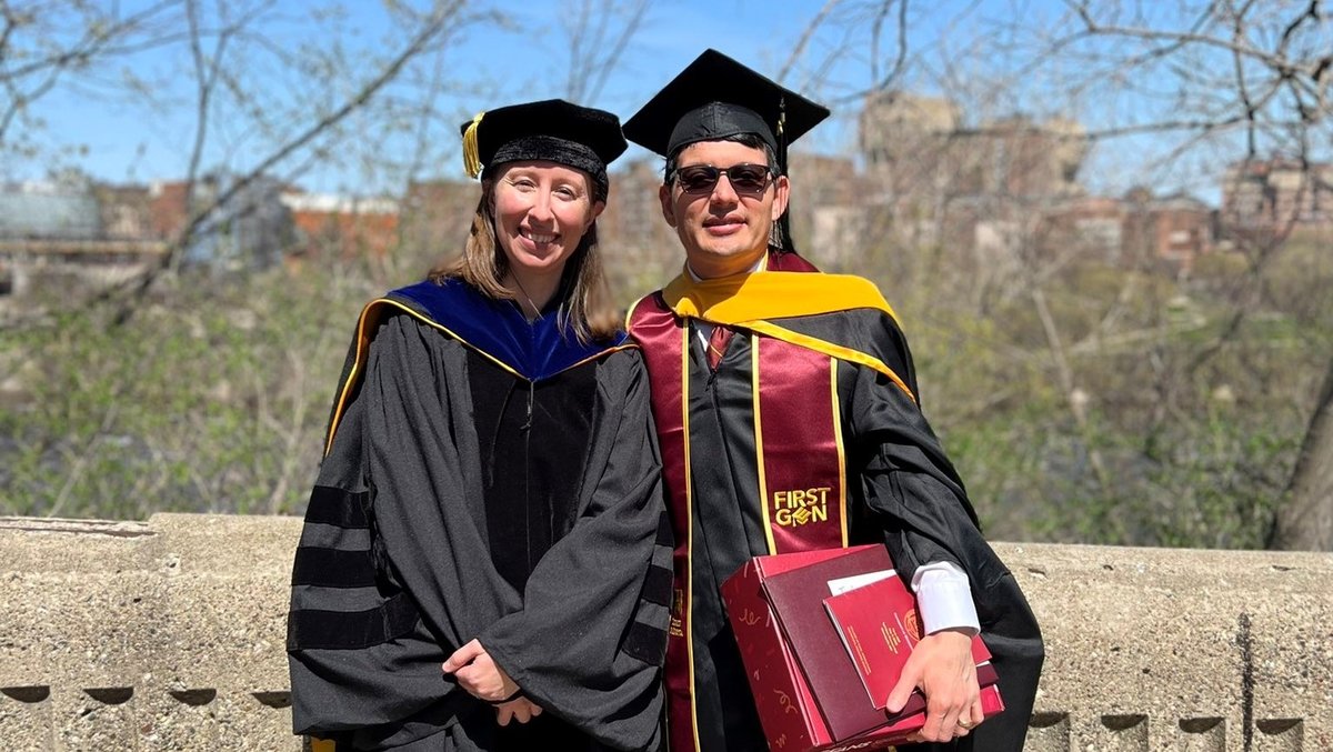 A photo of Dr. Melissa Wilson and Luis Allen in graduation regalia 